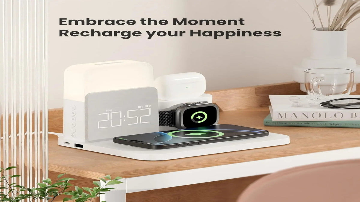 Wireless charging station with clock, phone, and smartwatch on a desk with motivational text.